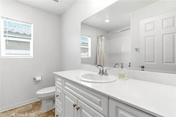 a bathroom with a sink toilet and mirror