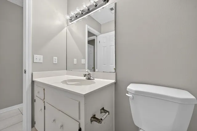 a spacious bathroom with a double vanity sink mirror and bathtub