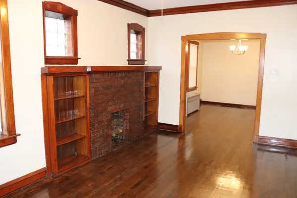 a view of entryway with wooden floor and fan