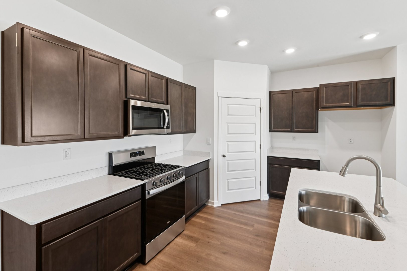 829 Mesa Lane Pingree Grove, IL 60140 - Photo 13 of 55 a kitchen with granite countertop a sink and a stove top oven with wooden floor