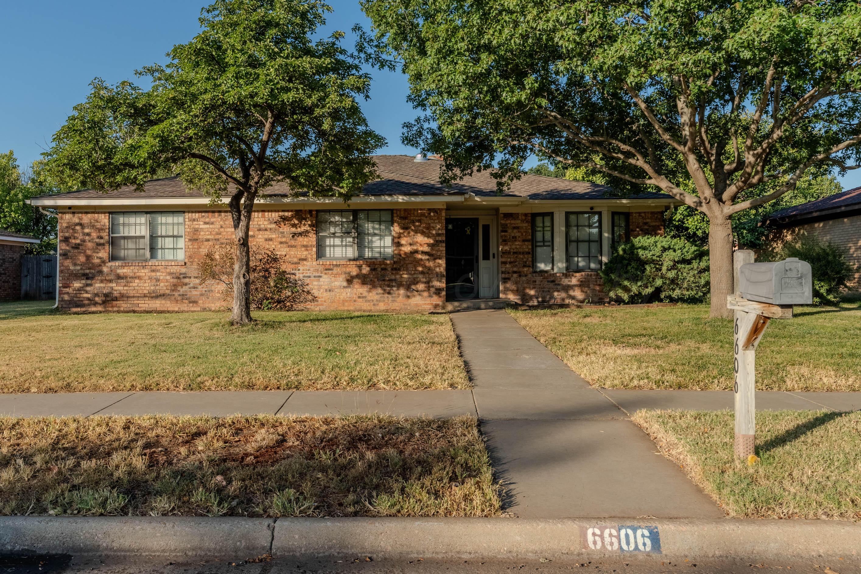 6606 Drexel Road Amarillo, TX 79109 - Photo 1 of 44 a front view of a house with garden