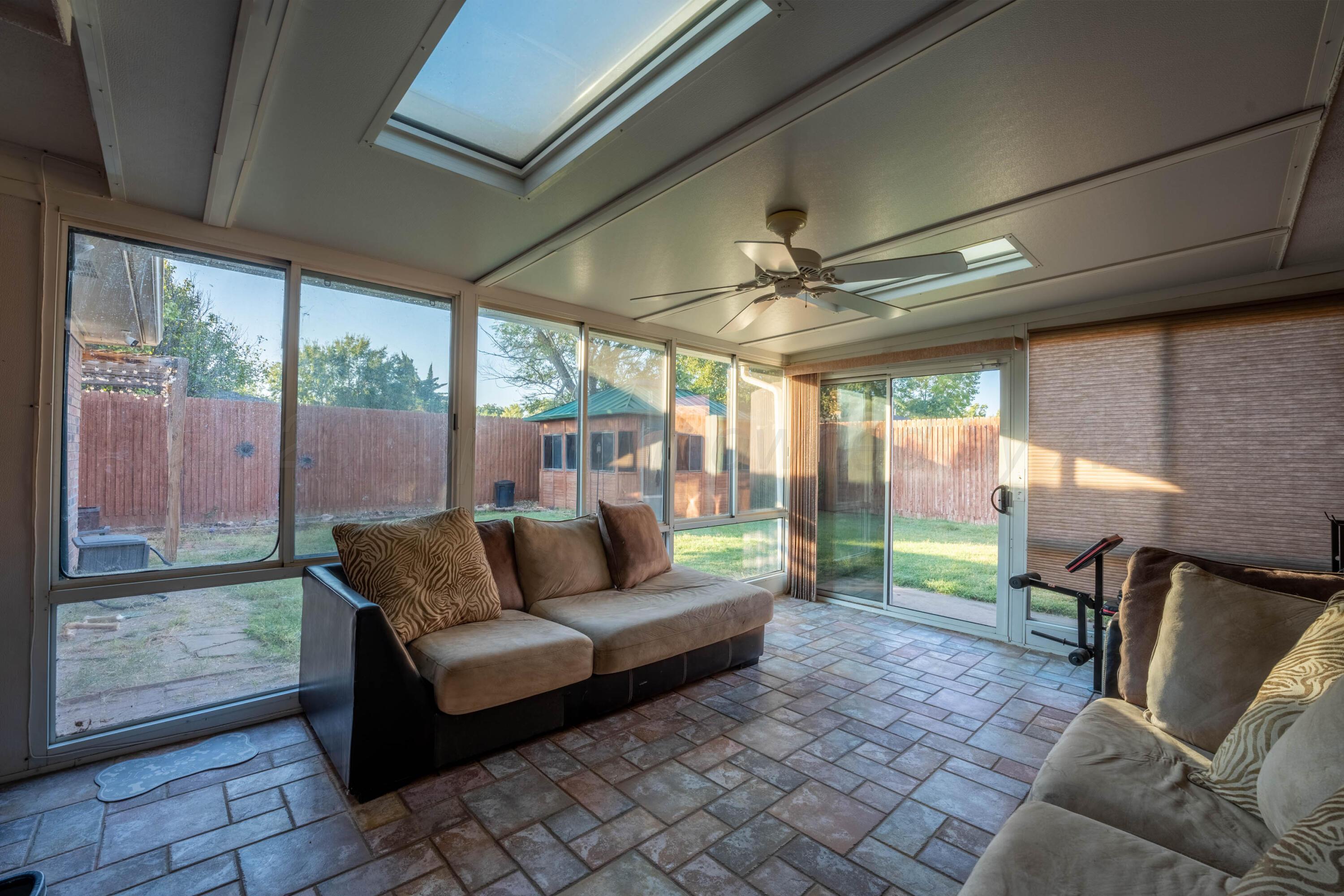 6606 Drexel Road Amarillo, TX 79109 - Photo 12 of 44 a living room with furniture and a floor to ceiling window