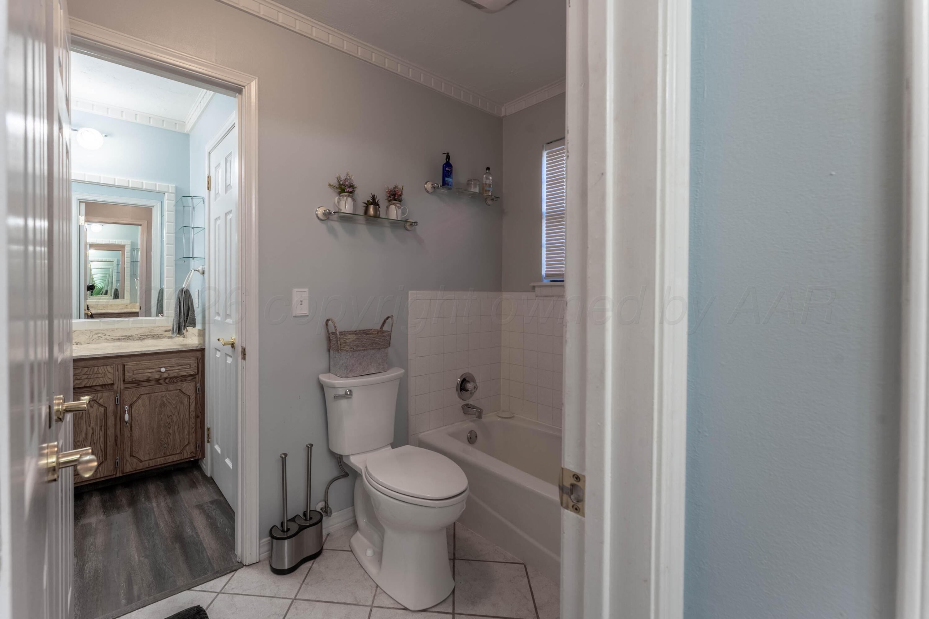 6606 Drexel Road Amarillo, TX 79109 - Photo 30 of 44 a bathroom with a toilet and a shower