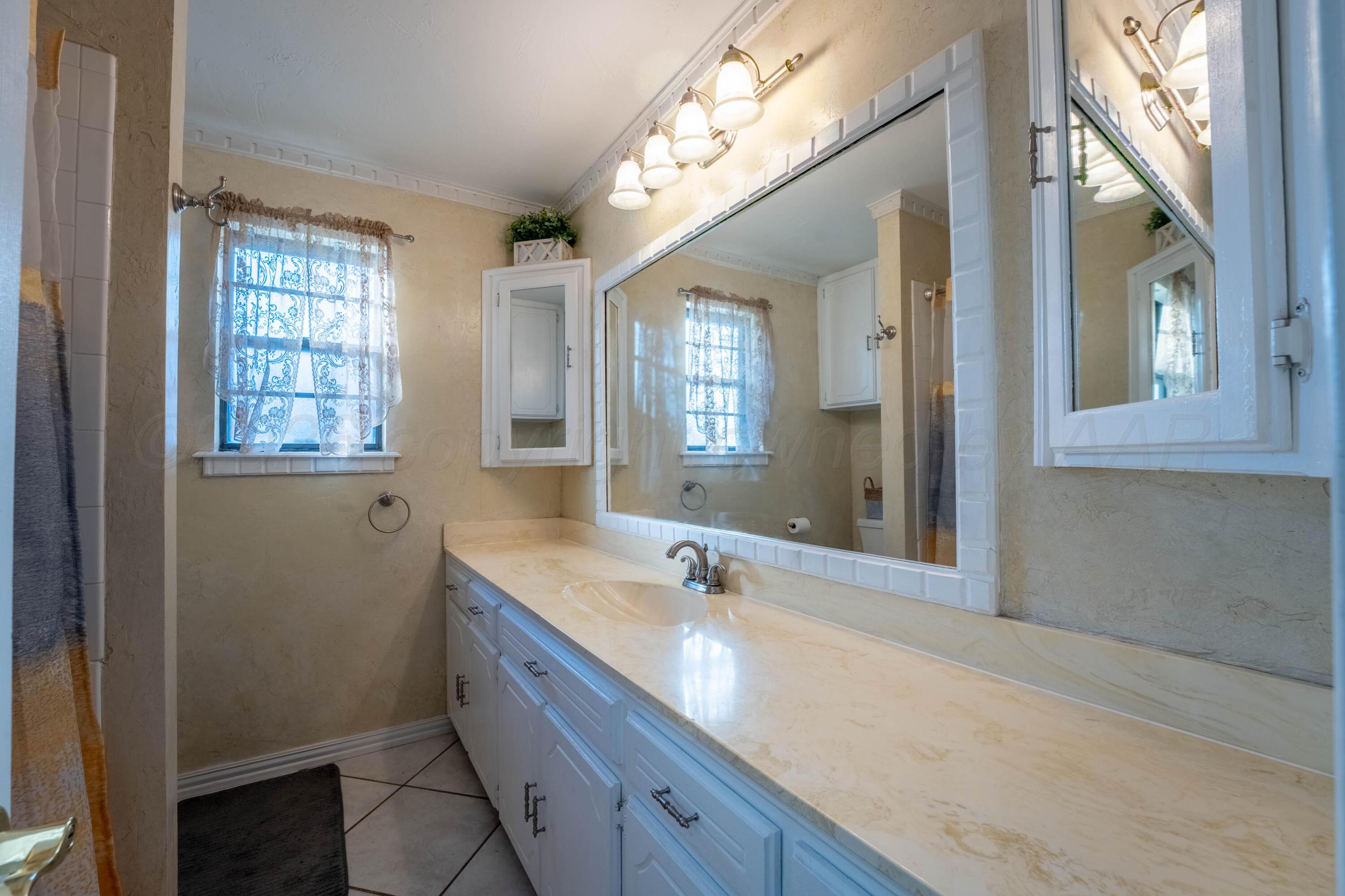 6606 Drexel Road Amarillo, TX 79109 - Photo 34 of 44 a bathroom with a sink double vanity and a mirror