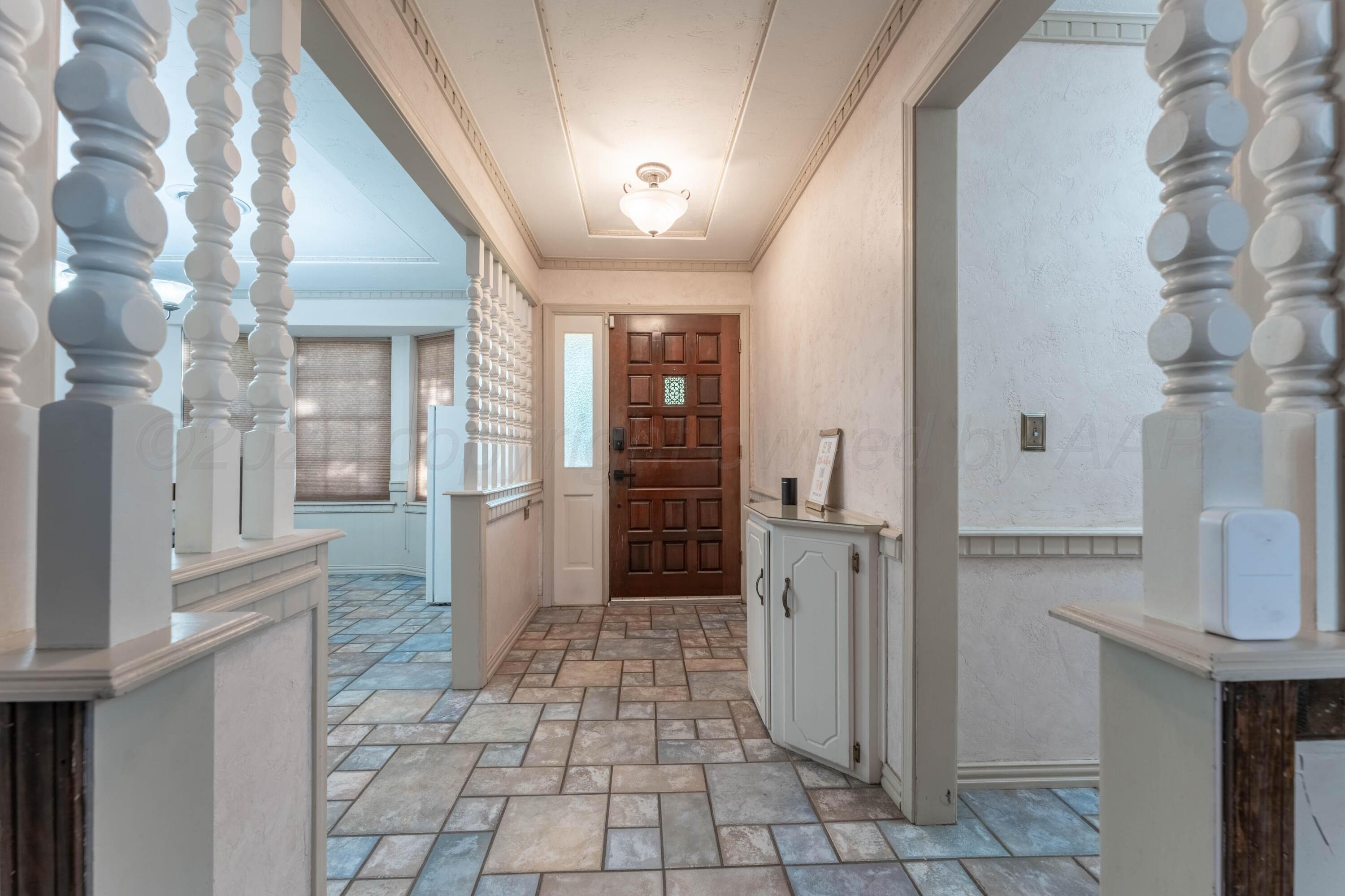 6606 Drexel Road Amarillo, TX 79109 - Photo 5 of 44 a view of a hallway with wooden floor and staircase