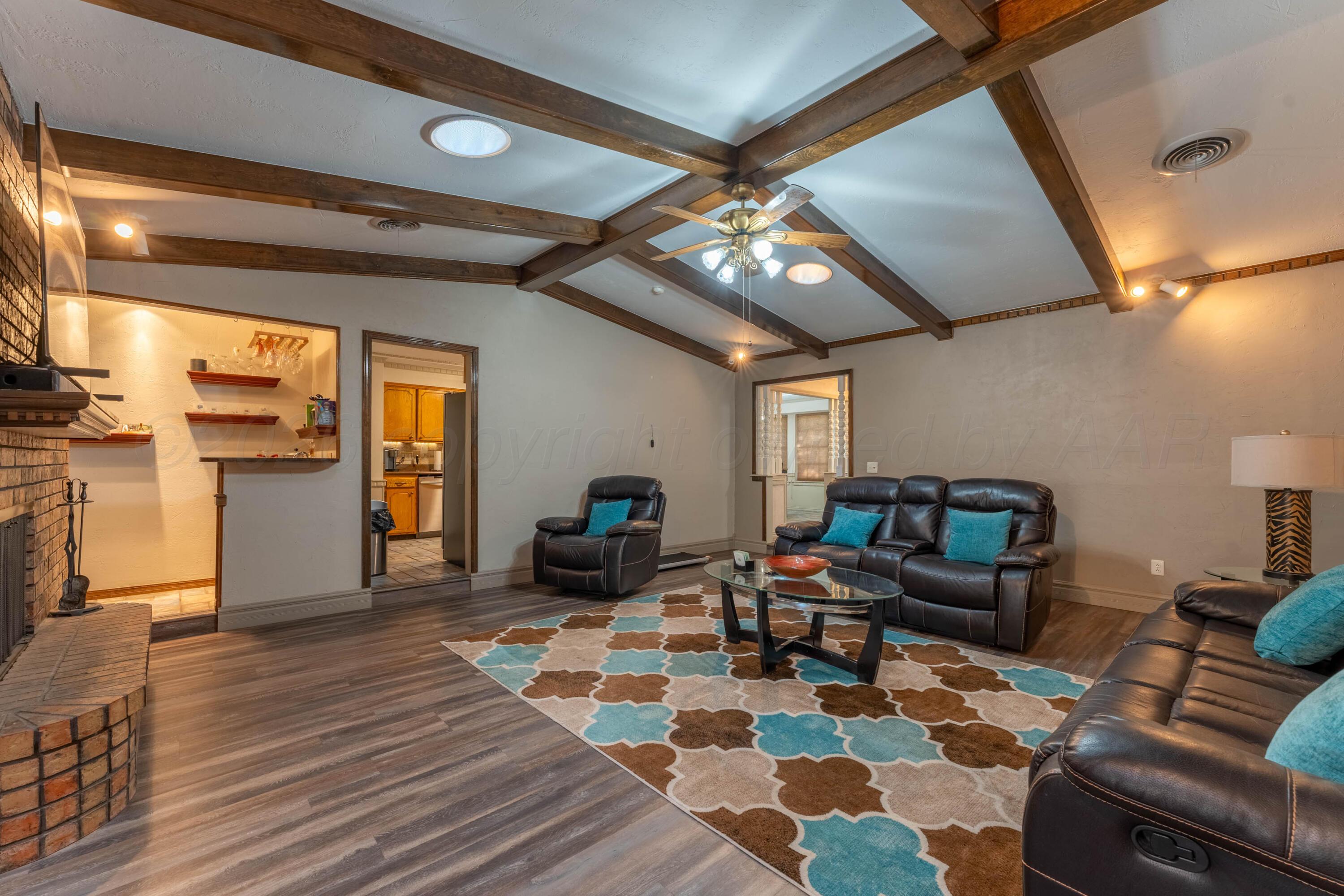 6606 Drexel Road Amarillo, TX 79109 - Photo 9 of 44 a living room with furniture and a flat screen tv