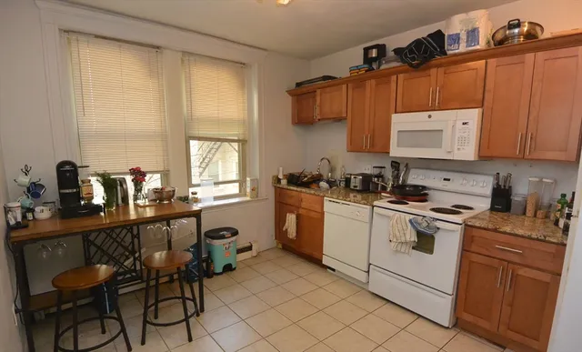 a kitchen with a sink cabinets and window