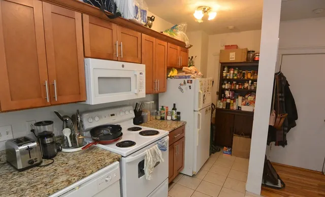 a kitchen with a stove and a refrigerator