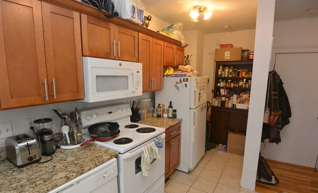 24 Ransom Road, Unit 6 Boston, MA 02135 - Photo 2 of 7 a kitchen with a stove and a refrigerator
