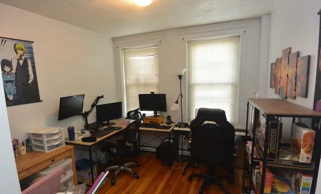 a view of a workspace with furniture and a window