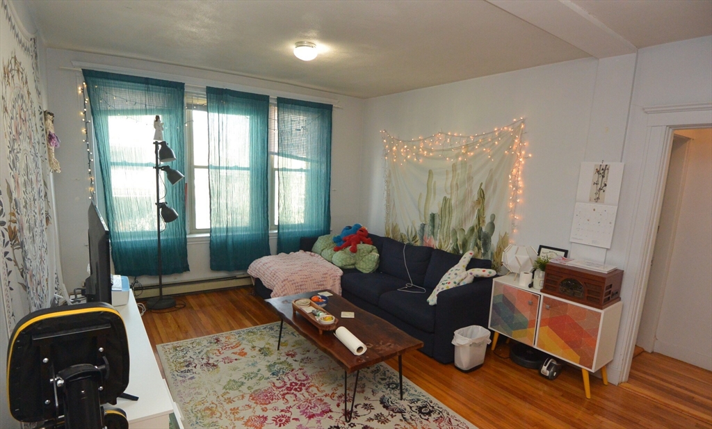 24 Ransom Road, Unit 6 Boston, MA 02135 - Photo 4 of 7 a living room with furniture and wooden floor