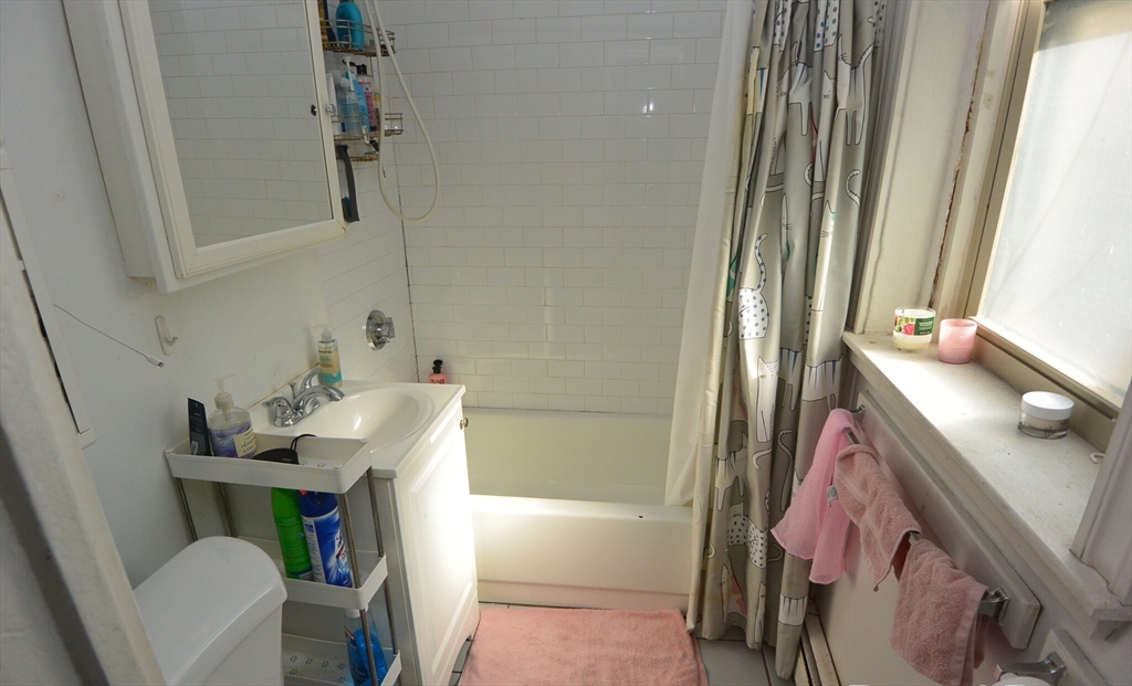 24 Ransom Road, Unit 6 Boston, MA 02135 - Photo 6 of 7 a bathroom with a sink toilet and shower