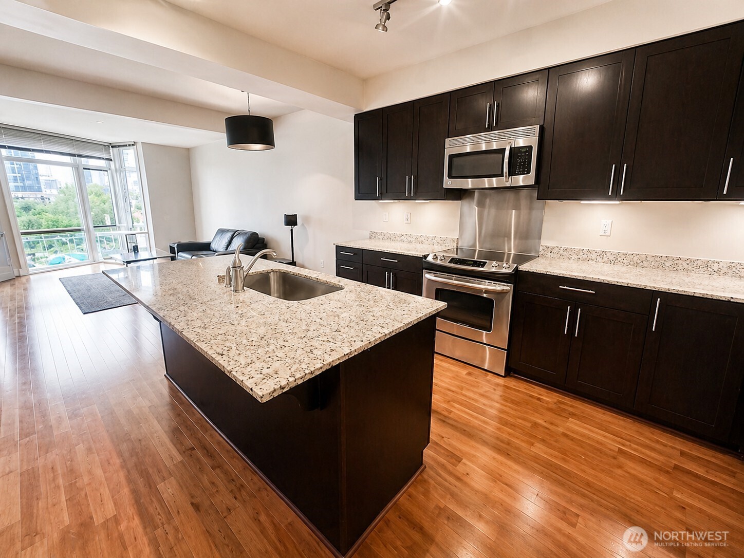 699 John Street, Unit 515 Seattle, WA 98109 - Photo 1 of 26 a kitchen with stainless steel appliances granite countertop a sink dishwasher stove and oven with wooden floor