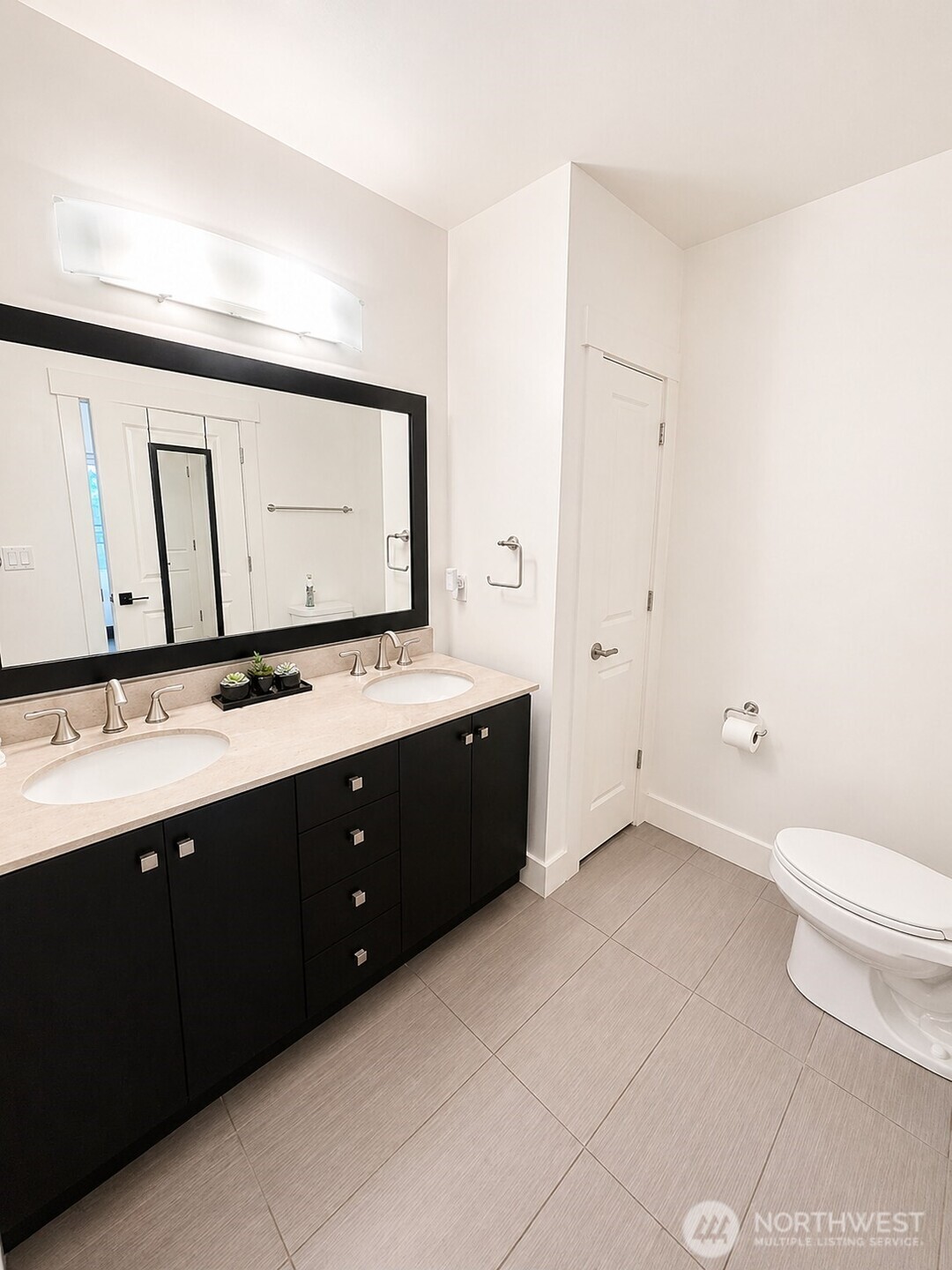 699 John Street, Unit 515 Seattle, WA 98109 - Photo 17 of 26 a bathroom with a toilet sink and mirror