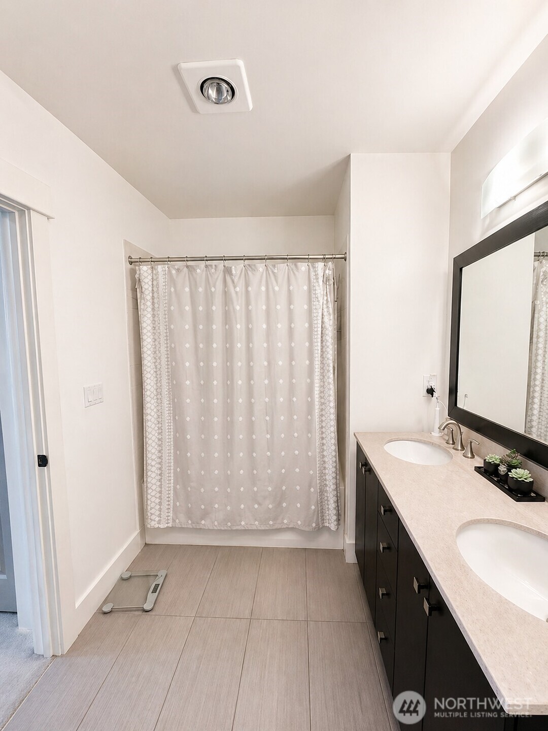 699 John Street, Unit 515 Seattle, WA 98109 - Photo 19 of 26 a bathroom with a double vanity sink and a mirror