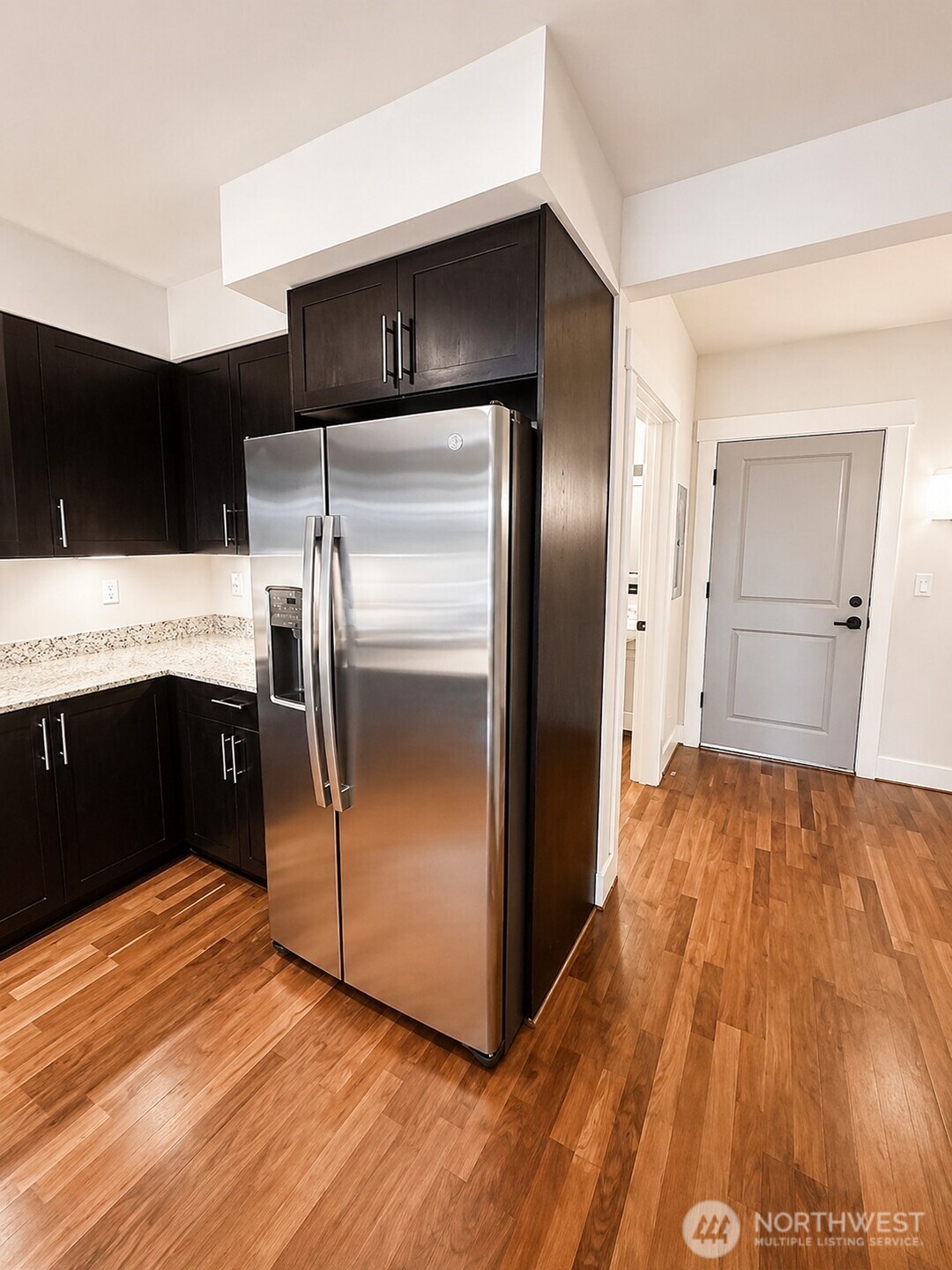 699 John Street, Unit 515 Seattle, WA 98109 - Photo 5 of 26 a kitchen with a refrigerator and a sink