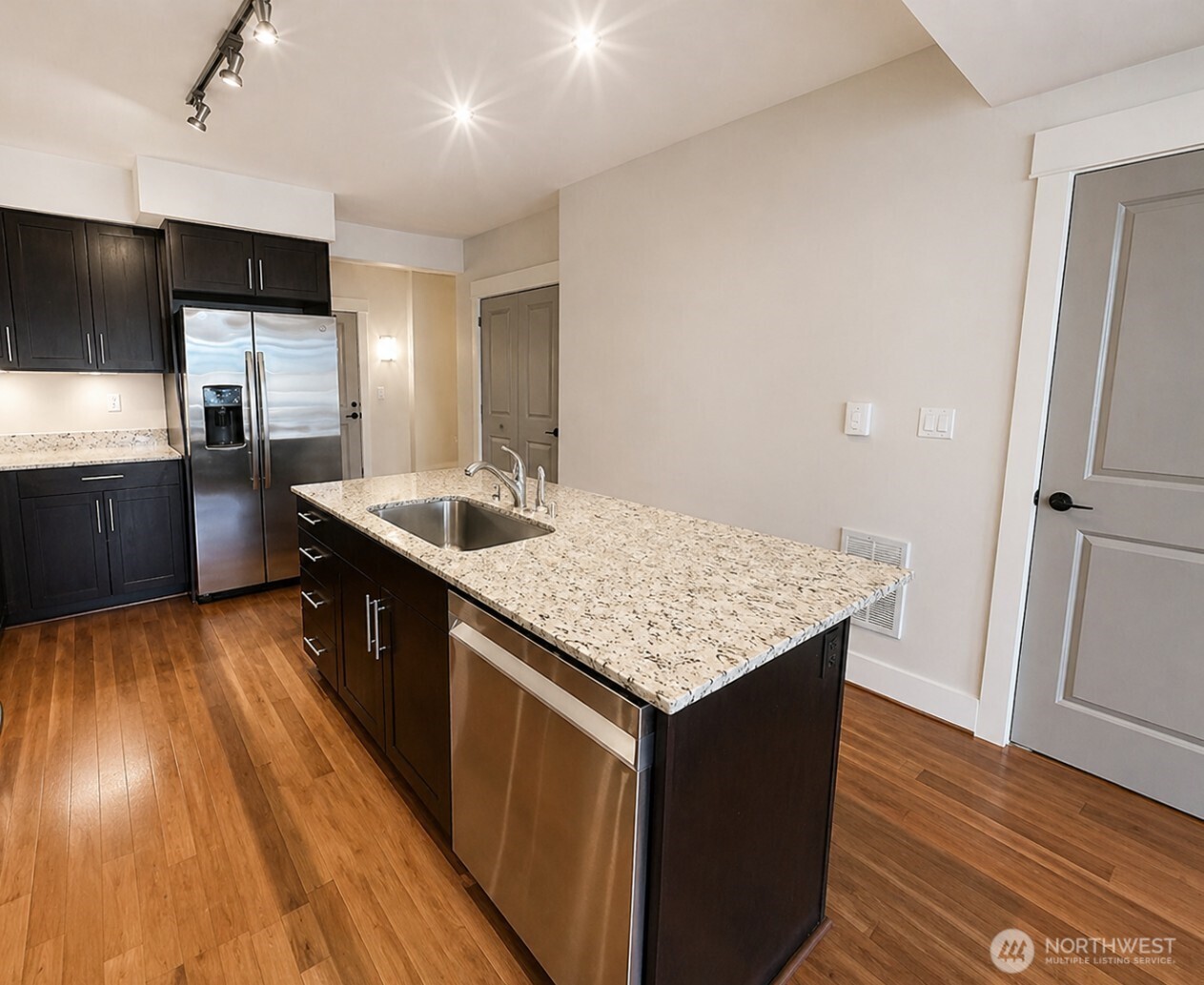699 John Street, Unit 515 Seattle, WA 98109 - Photo 6 of 26 a kitchen with stainless steel appliances granite countertop a sink stove and refrigerator
