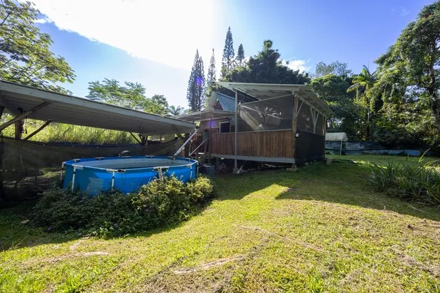 a view of a house with a backyard