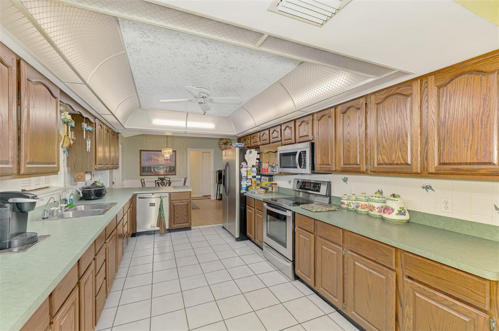 1137 Ponderosa Road Venice, FL 34293 - Photo 20 of 48 a kitchen with a sink a counter top space stainless steel appliances and cabinets