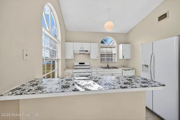 a kitchen with stainless steel appliances granite countertop a stove sink and cabinets
