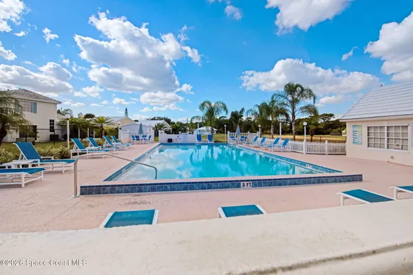 a view of swimming pool with outdoor seating and city view