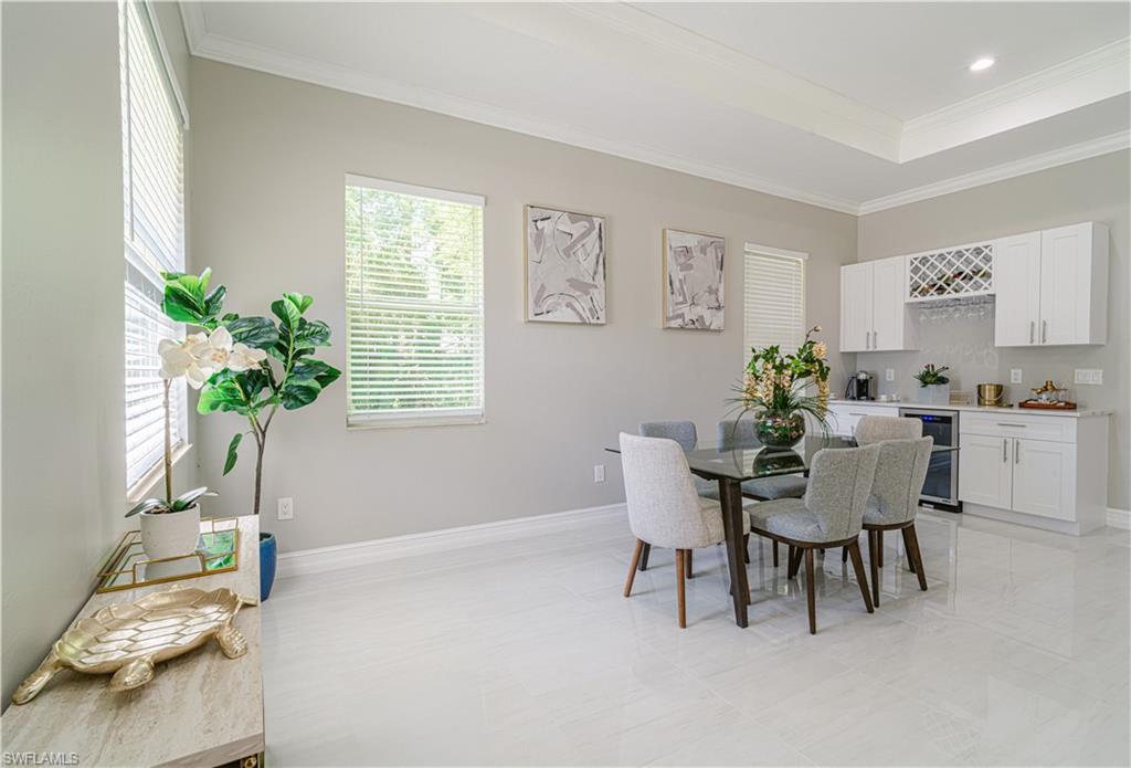 131 25th Street Southwest Naples, FL 34117 - Photo 11 of 50 a dining room with furniture and a potted plant