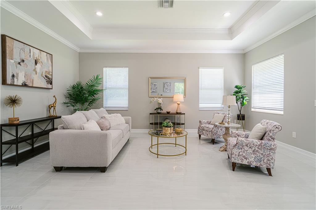131 25th Street Southwest Naples, FL 34117 - Photo 12 of 50 a living room with furniture and a large window