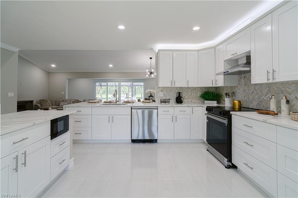 131 25th Street Southwest Naples, FL 34117 - Photo 50 of 50 a kitchen with white cabinets appliances and sink