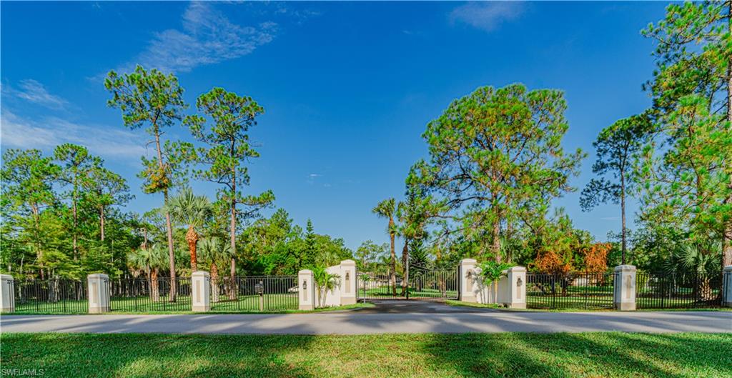 131 25th Street Southwest Naples, FL 34117 - Photo 2 of 50 a green field with lots of trees