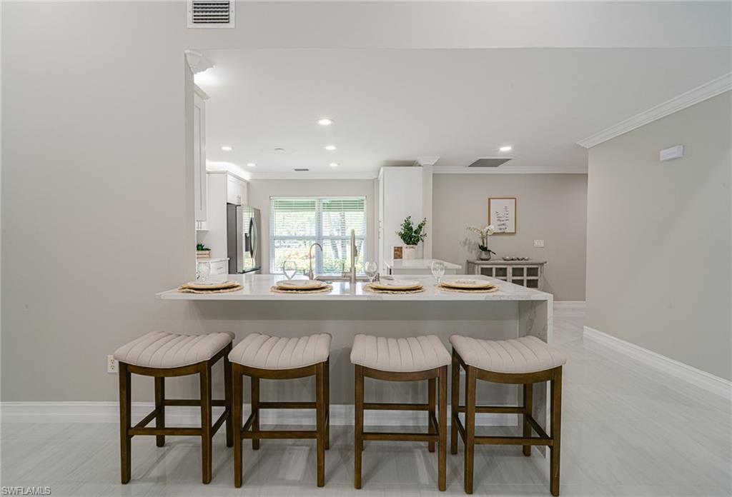 131 25th Street Southwest Naples, FL 34117 - Photo 20 of 50 a kitchen with a table and chairs in it