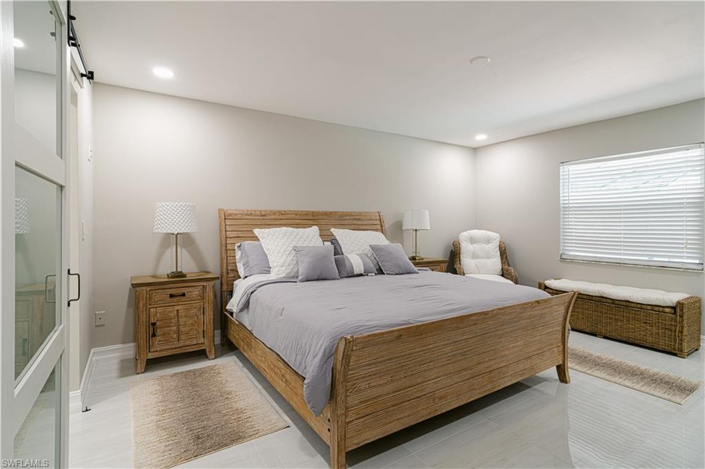 131 25th Street Southwest Naples, FL 34117 - Photo 24 of 50 a bedroom with a bed and window