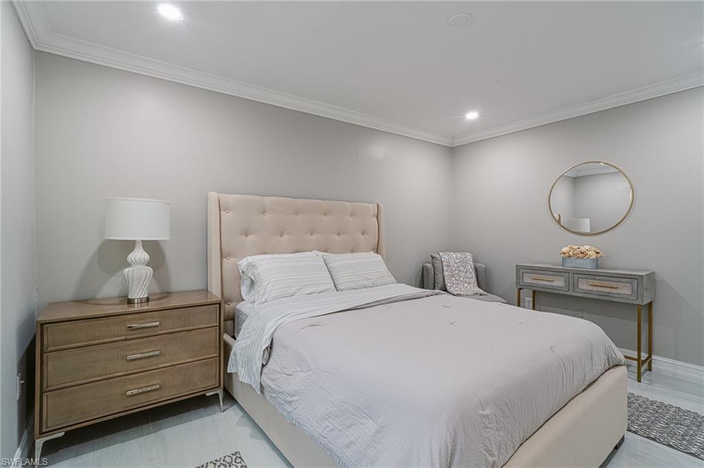 131 25th Street Southwest Naples, FL 34117 - Photo 31 of 50 a bedroom with a bed and a dresser