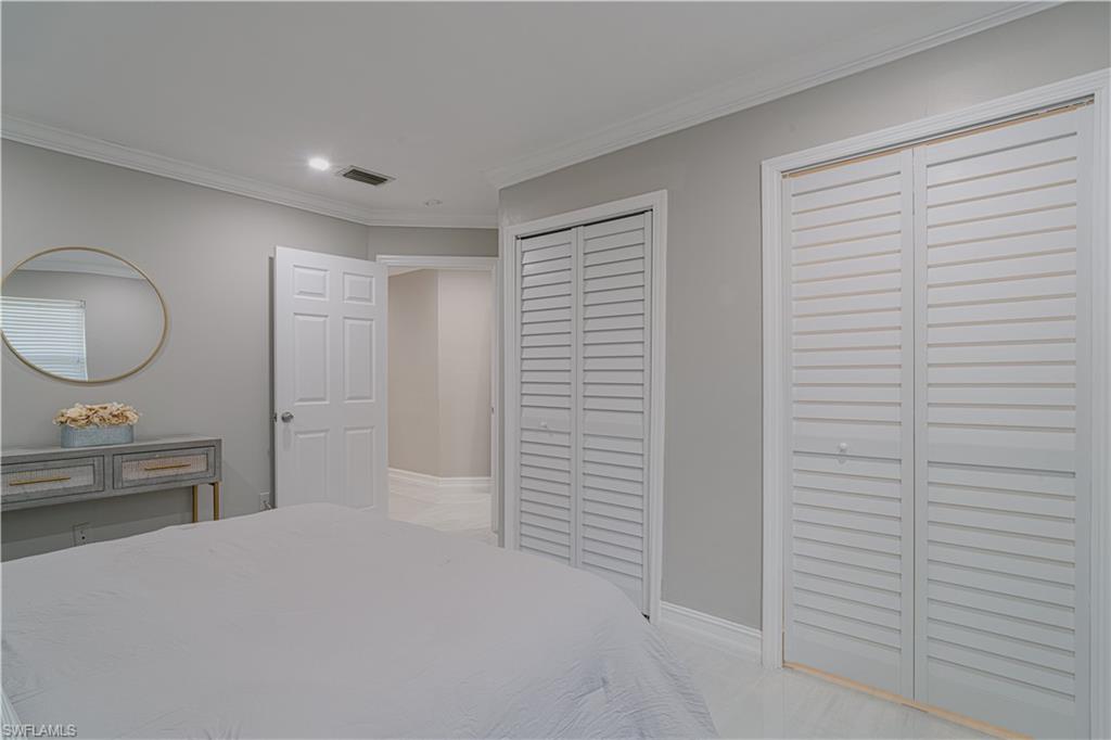 131 25th Street Southwest Naples, FL 34117 - Photo 32 of 50 a bedroom with a sink and a mirror