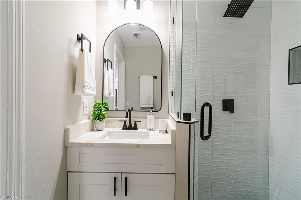 131 25th Street Southwest Naples, FL 34117 - Photo 33 of 50 a bathroom with a sink and a mirror