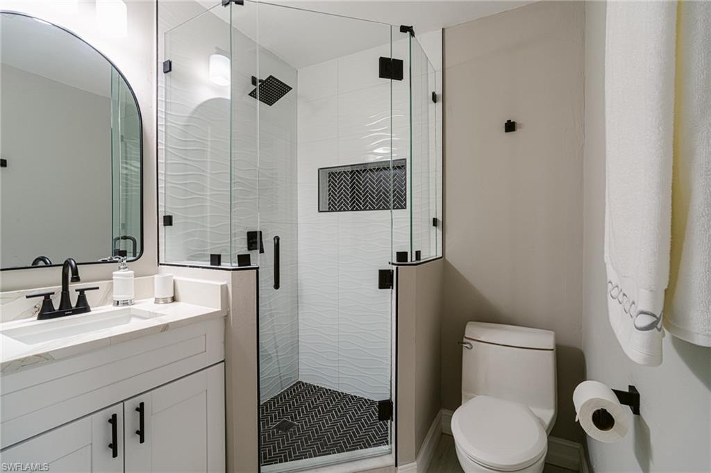 131 25th Street Southwest Naples, FL 34117 - Photo 34 of 50 a bathroom with a toilet a sink and shower
