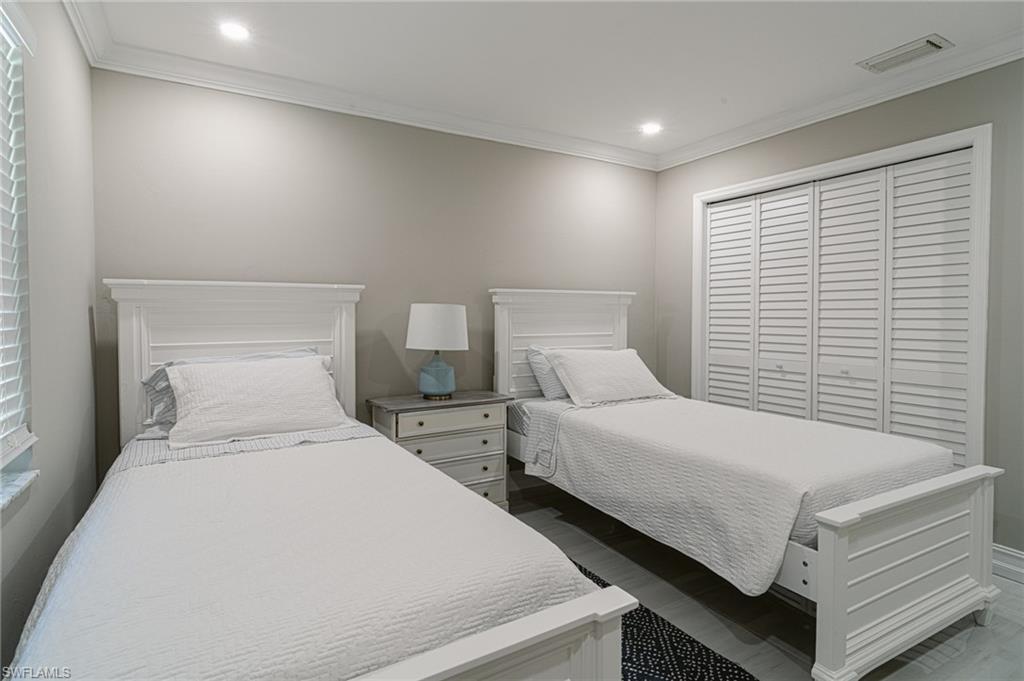 131 25th Street Southwest Naples, FL 34117 - Photo 35 of 50 a bedroom with two beds and a night stand