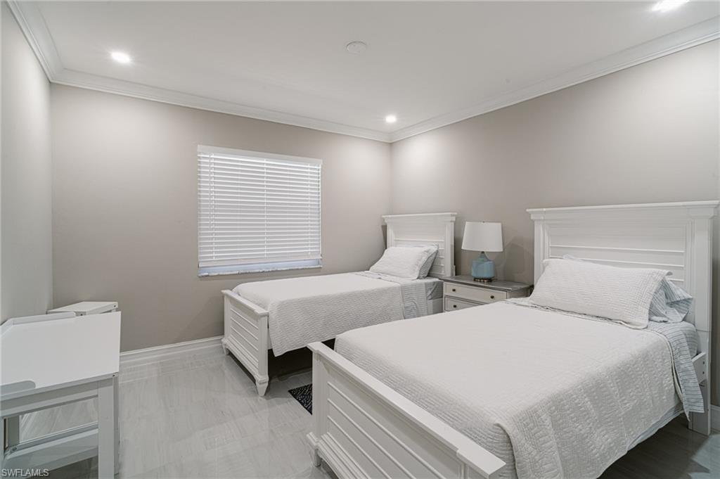 131 25th Street Southwest Naples, FL 34117 - Photo 36 of 50 a bedroom with two beds and a window