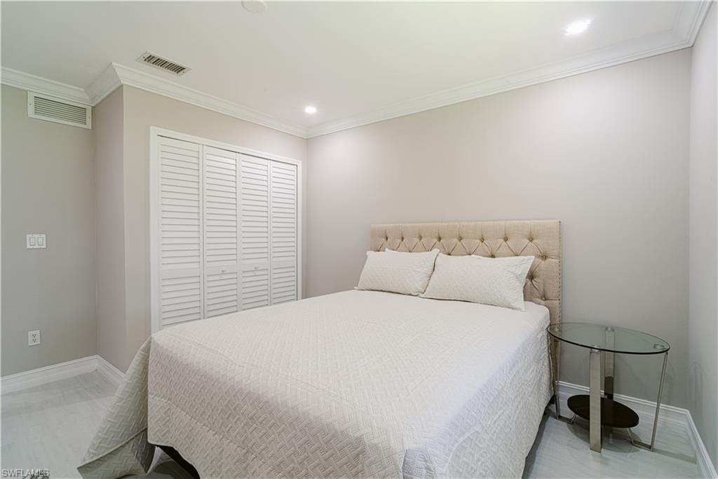 131 25th Street Southwest Naples, FL 34117 - Photo 43 of 50 a large bed sitting in a bedroom next to a window