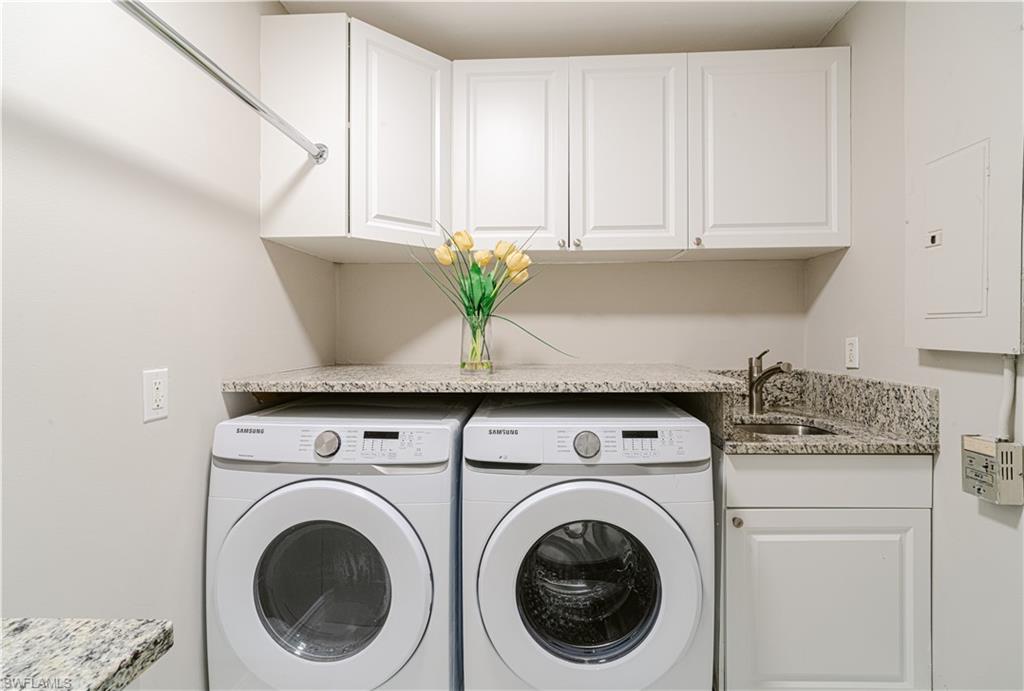 131 25th Street Southwest Naples, FL 34117 - Photo 44 of 50 a view of washer and dryer with kitchen countertops