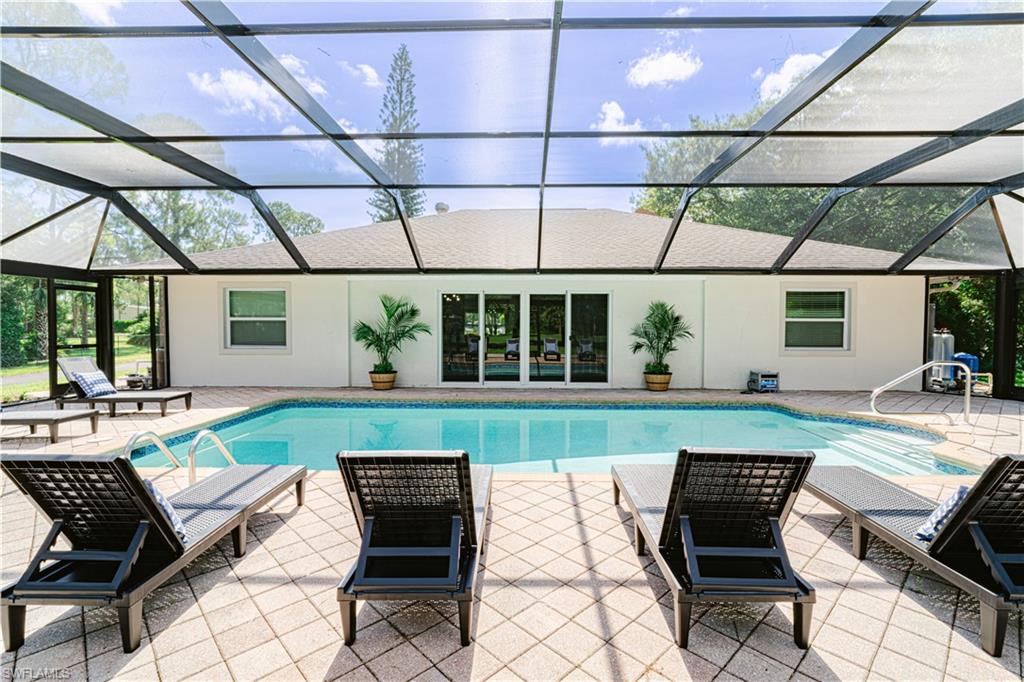 131 25th Street Southwest Naples, FL 34117 - Photo 46 of 50 a swimming pool with outdoor seating and yard