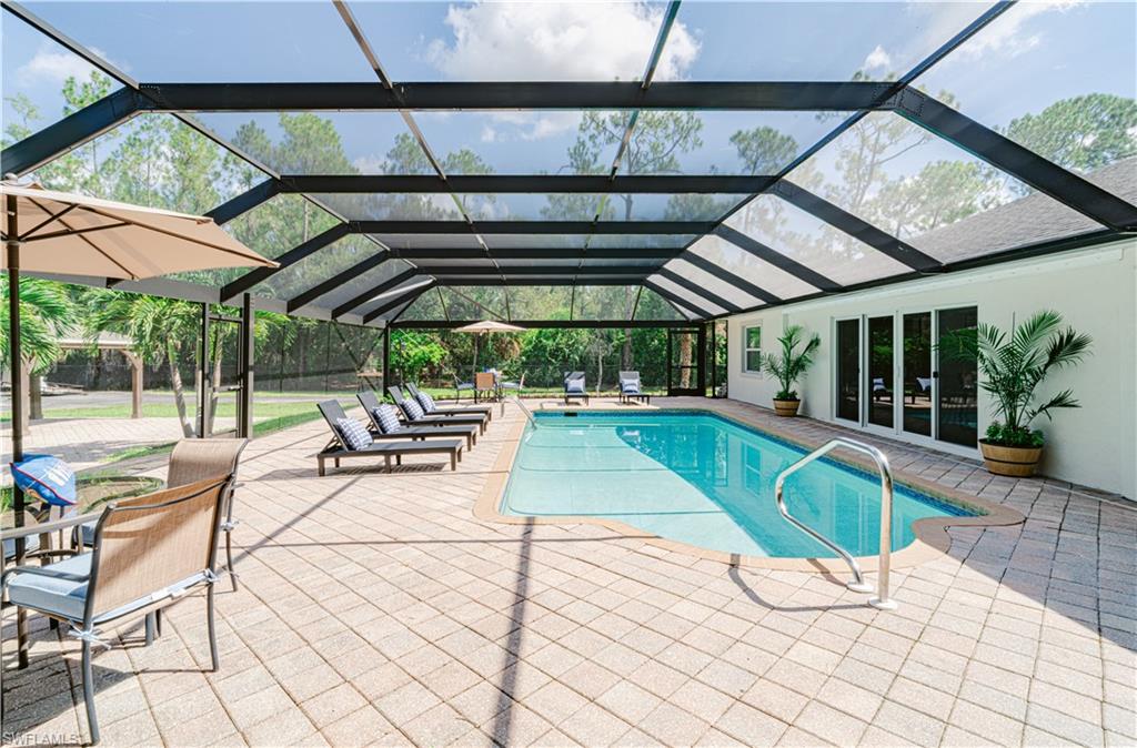 131 25th Street Southwest Naples, FL 34117 - Photo 47 of 50 a view of a swimming pool with a patio