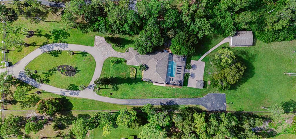 131 25th Street Southwest Naples, FL 34117 - Photo 5 of 50 an aerial view of a house with a yard and trees all around