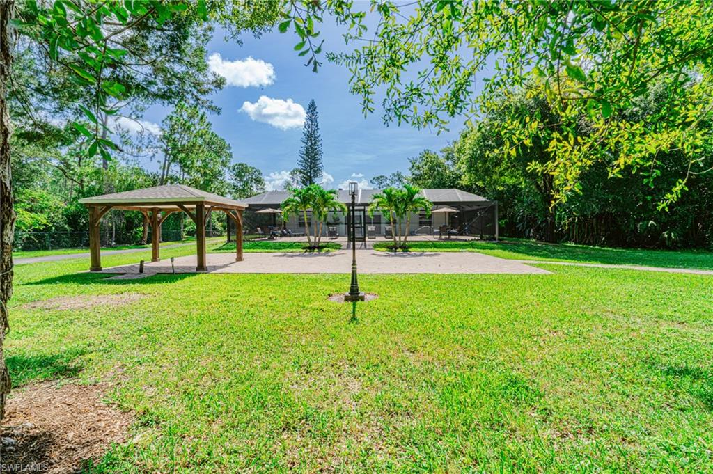 131 25th Street Southwest Naples, FL 34117 - Photo 8 of 50 a house view with a garden space