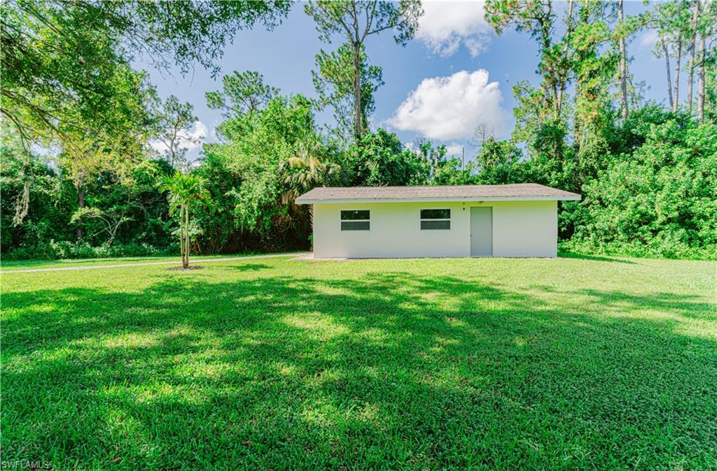 131 25th Street Southwest Naples, FL 34117 - Photo 9 of 50 a view of a house with a backyard
