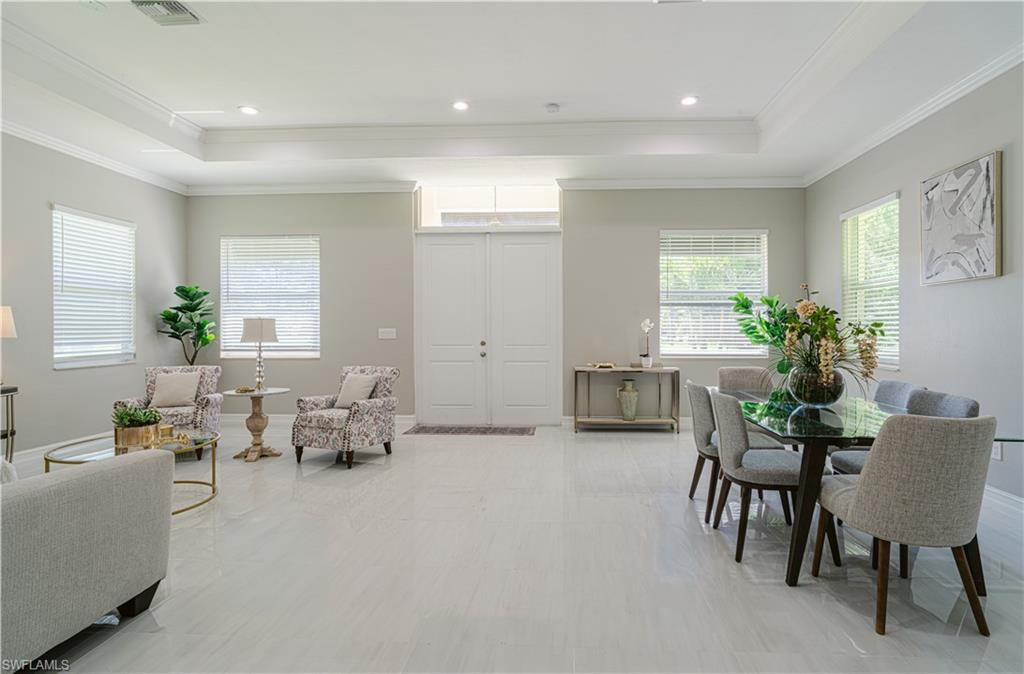 131 25th Street Southwest Naples, FL 34117 - Photo 10 of 50 a living room with furniture and a potted plant