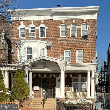 a front view of a building with a garden