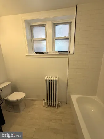 a bathroom with a sink a toilet and a bathtub