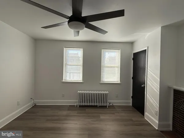 a view of a livingroom with a ceiling fan and window