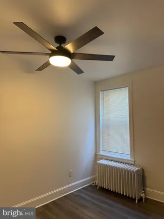 a view of room with window and wooden floor