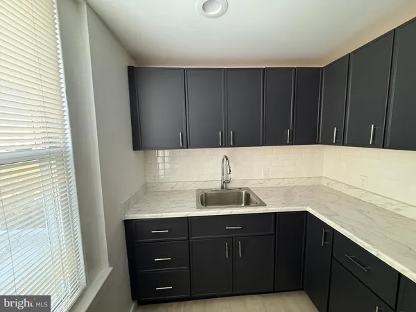 a kitchen with a sink and cabinets